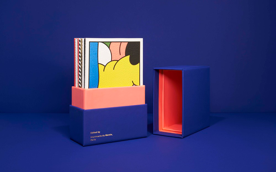 Livro com embalagem tipo caixa na cor azul com o seu interior na cor laranja.